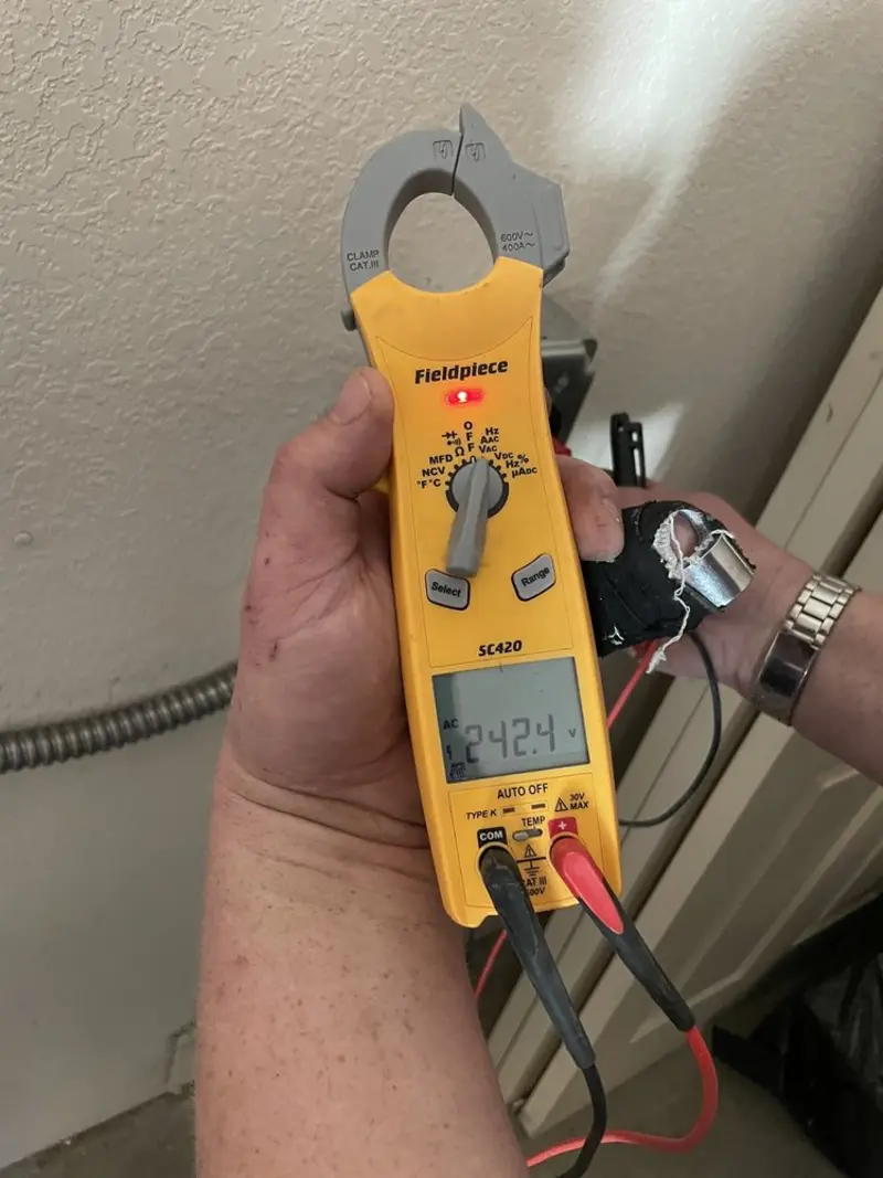 Voltage testing with clamp meter during Recessed Lighting Installation in Rockford